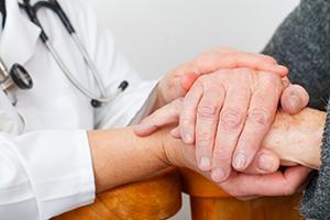 doctor's hands comforting patient