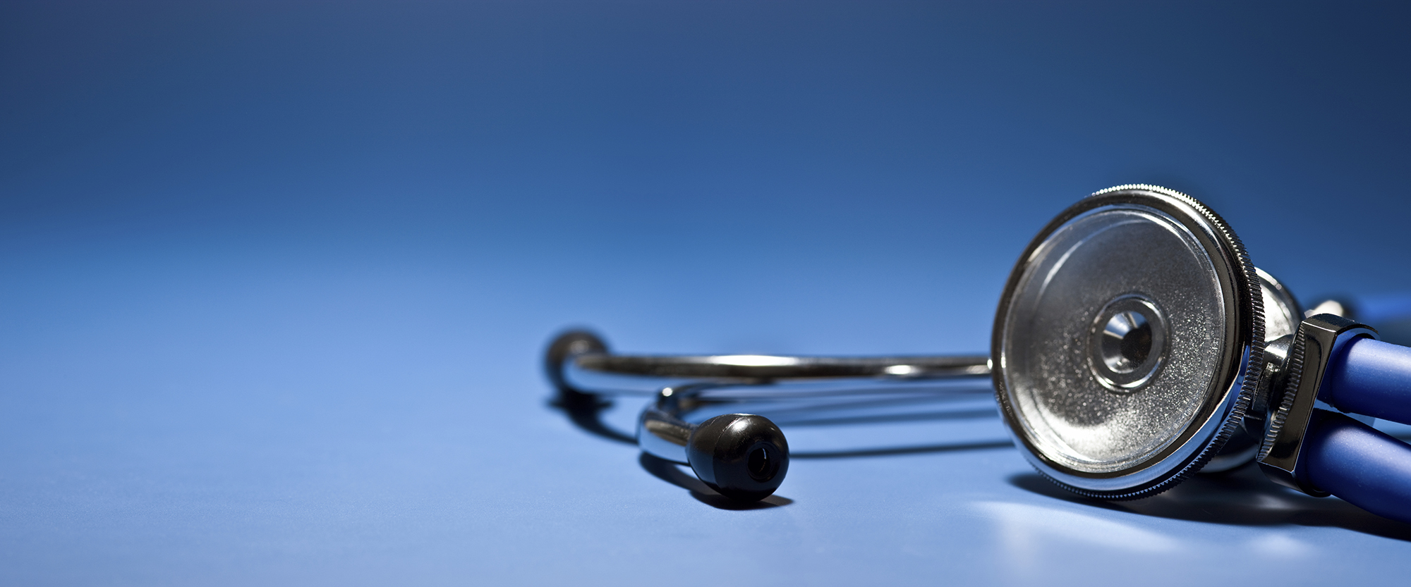 Risk Management News and Education stethoscope on blue background