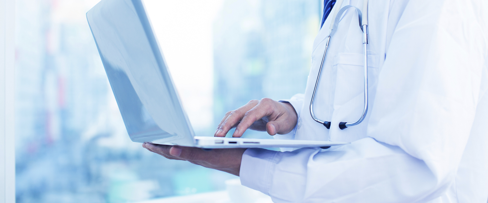 Risk Management Tools and Resources physician holding laptop computer
