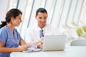 doctor and staff with laptop